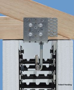 A close-up view of a structural connection showing a metal connector plate attaching wooden beams to an insulated concrete form (ICF) wall. The metal plate is secured with screws, and part of the form detail and reinforcing brackets are visible. The image has a "Patent Pending" mark.